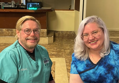 Dr. Hillock and staff smiling at dinner event