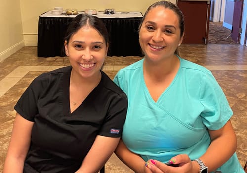 Two women smiling at a dinner event